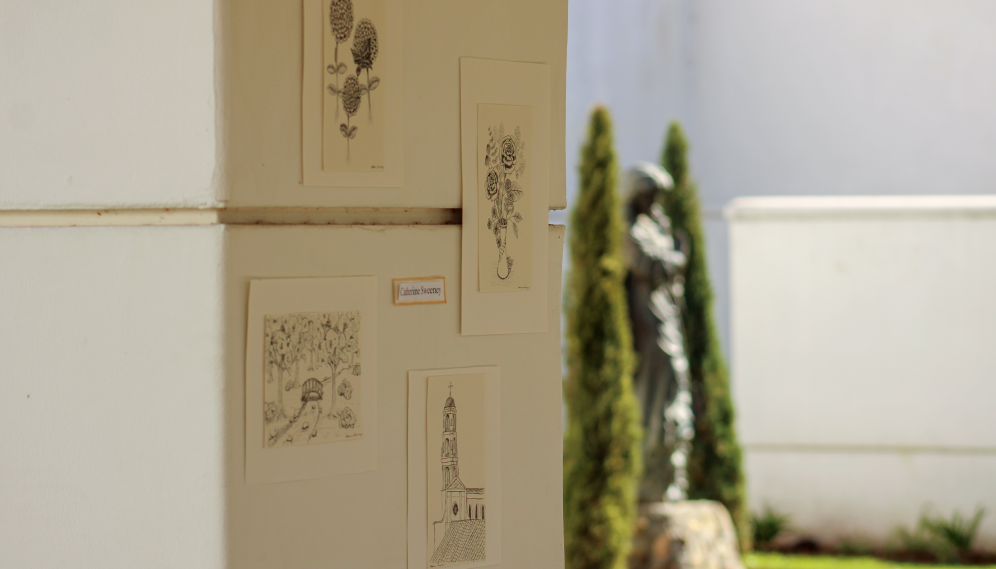 Four inked drawings by Catherine Sweeney on one of the pillars of the arcade