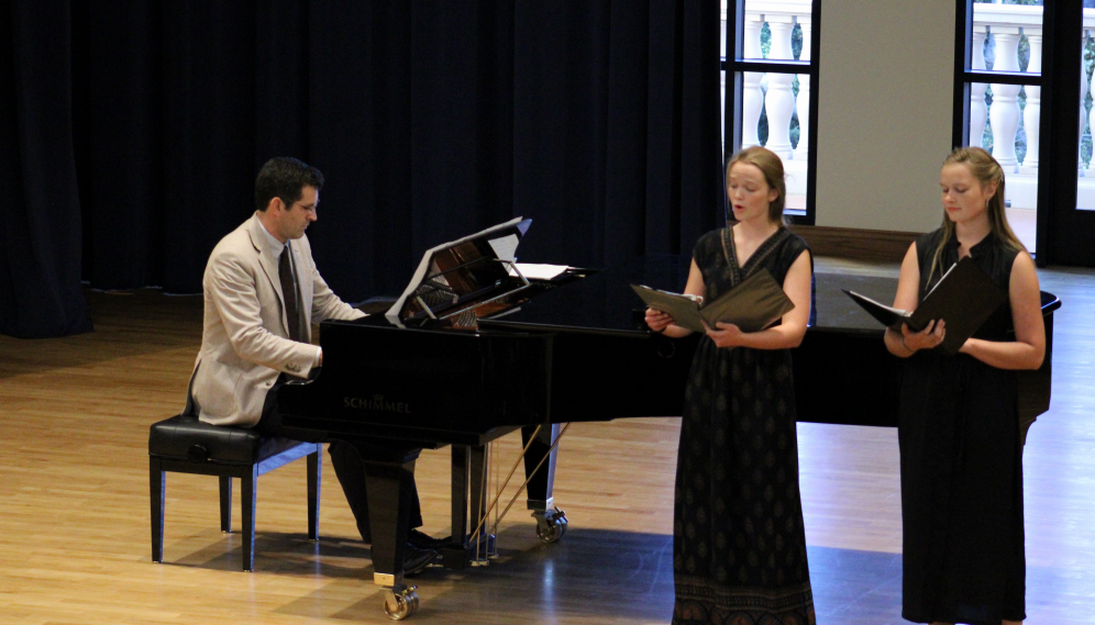 A pianist and two singers perform together