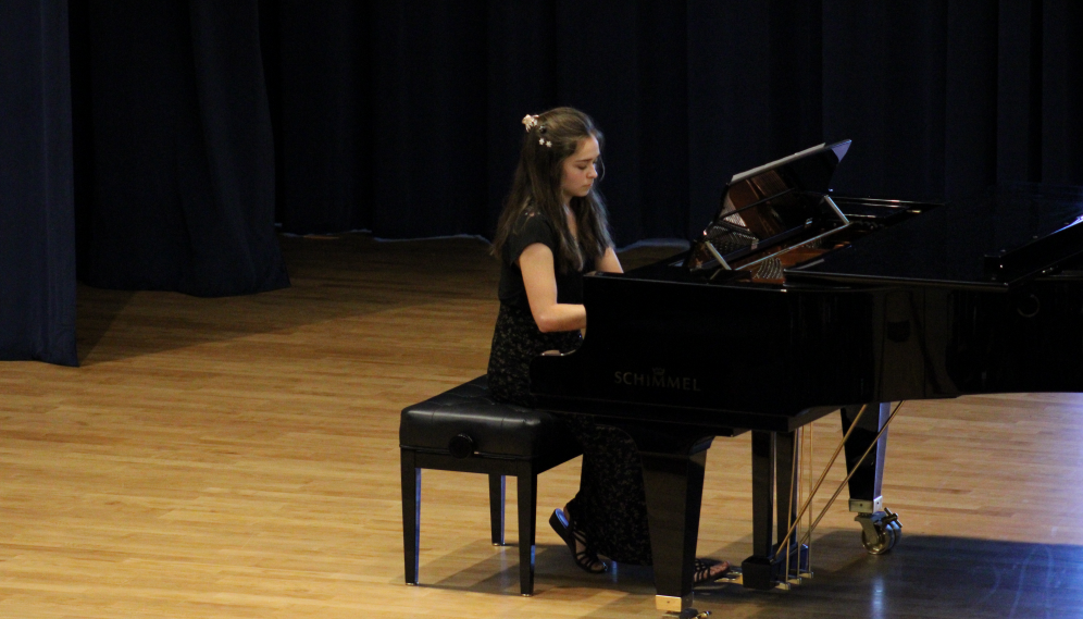 A student performs a piano solo