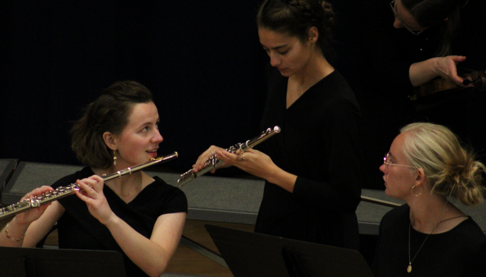 Two flutists get ready to perform