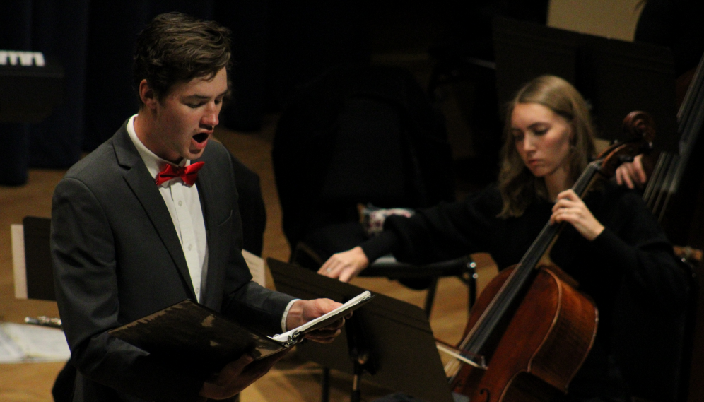 A singer sings while a cellist performs