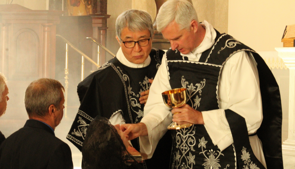 The priests distribute Communion