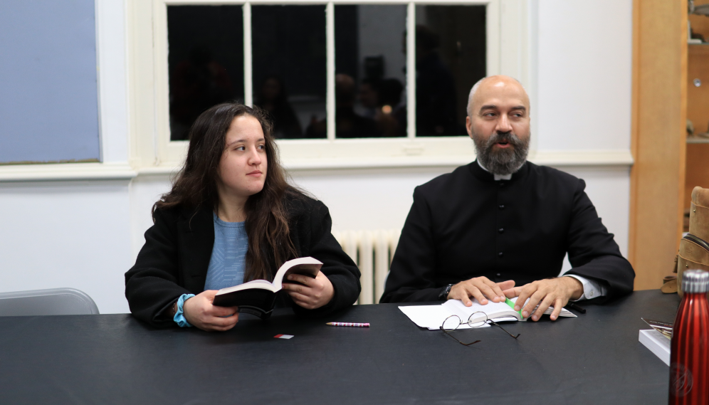 A student listens while Fr. Viego makes a point