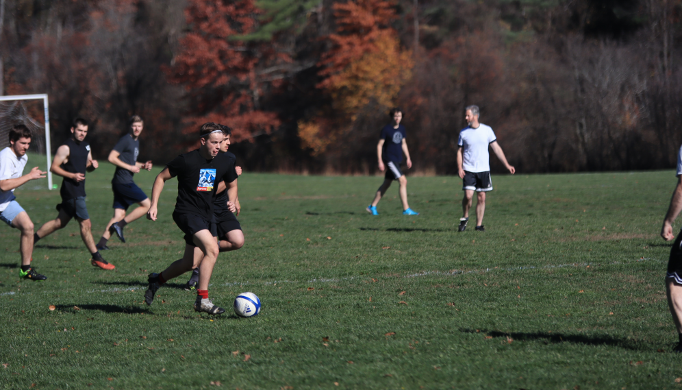 The black-clad team guides the ball up the field