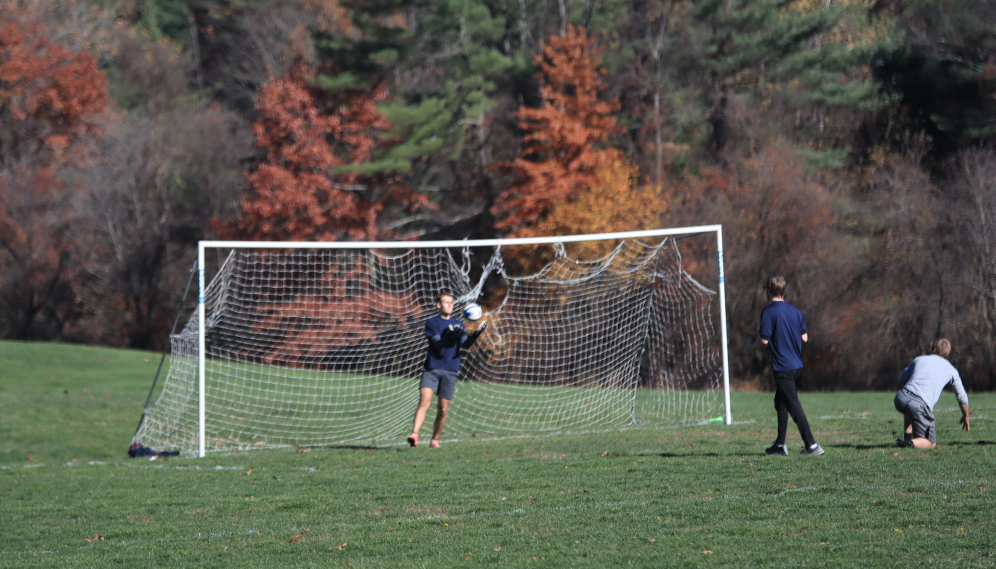 The goalie holds the ball