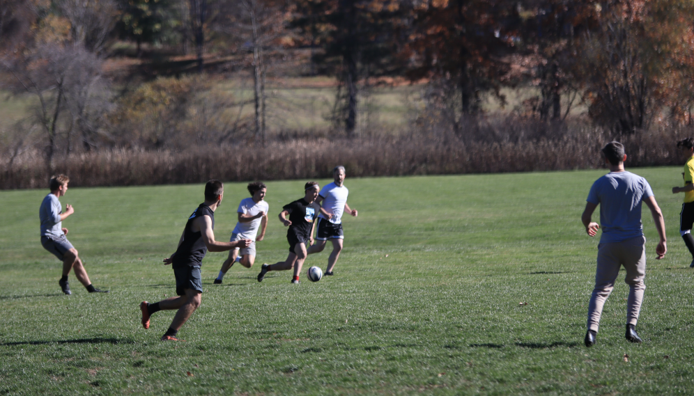A student guides the ball up the field