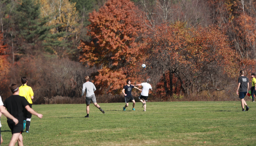 Two in competition for the ball, which is coming down from mid-air