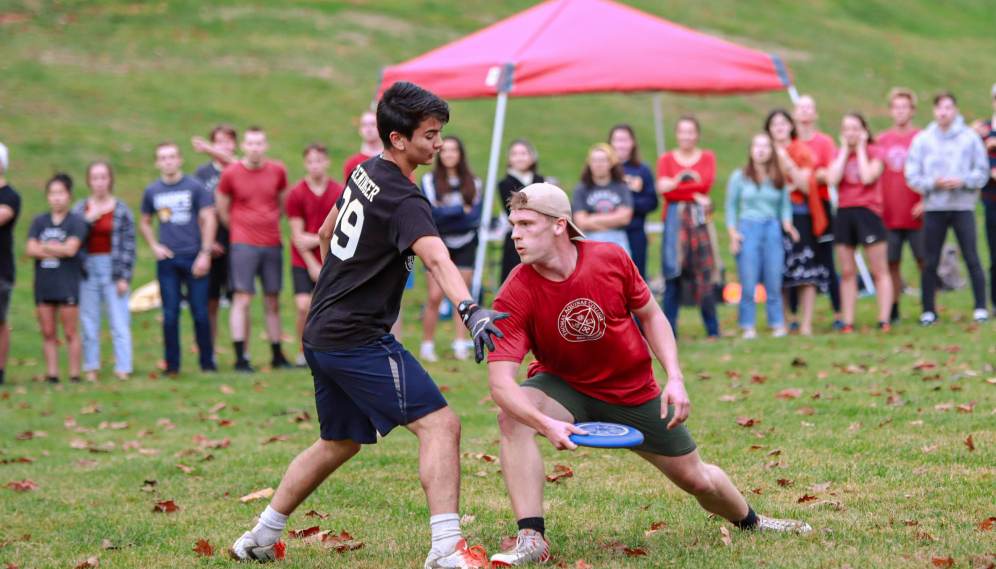 A TMC student blocks a TAC student attempting a low pass