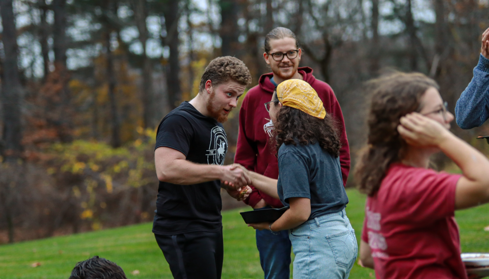 A TMC and TAC student shake hands and introduce themselves