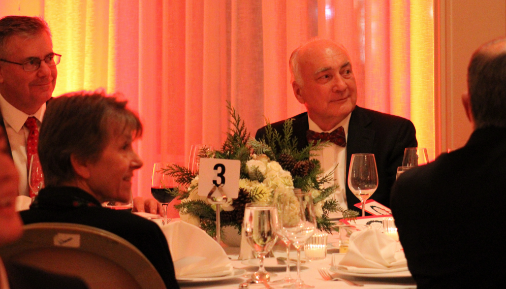 The attendees at table #3 listen to the speeches