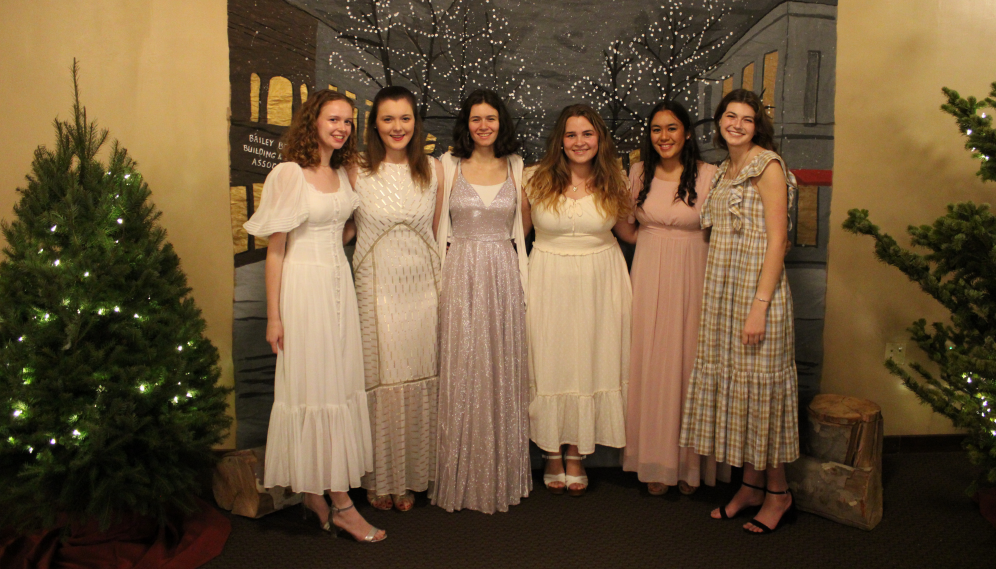 Six pose for a photo in their Christmas dresses