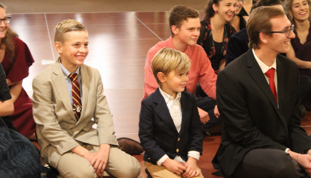 Tutor kids gather to watch Santa Claus read a story