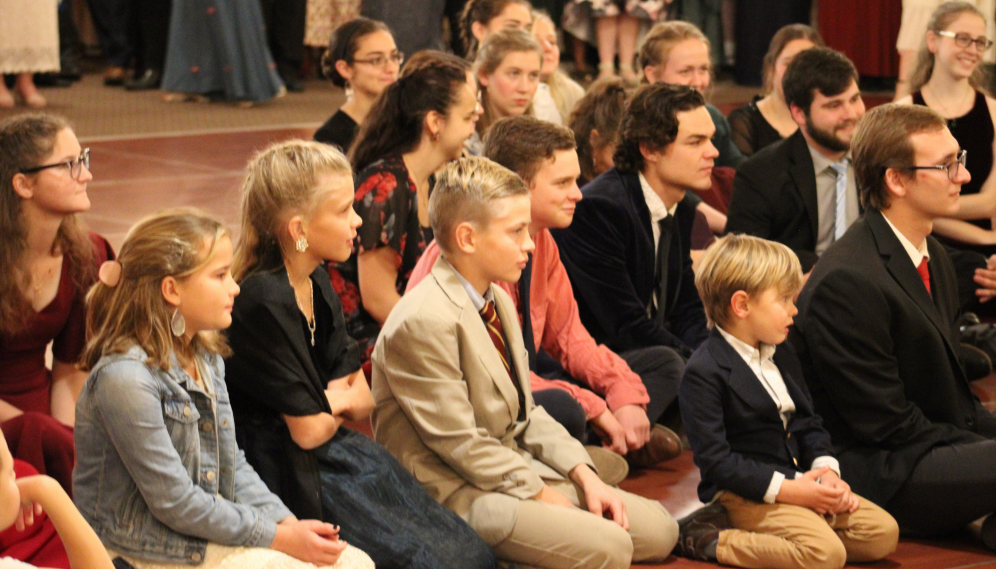 Students and children listen to the story