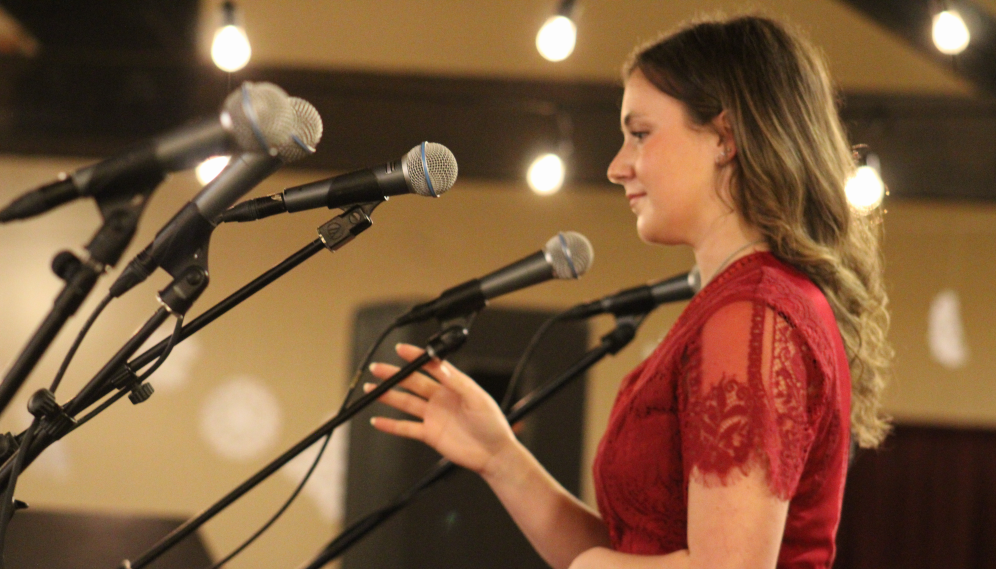 A student speaks into a row of mics