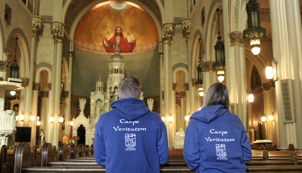 Two students pray in church