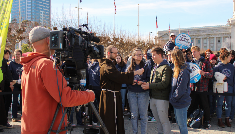 A student is interviewed by a news crew