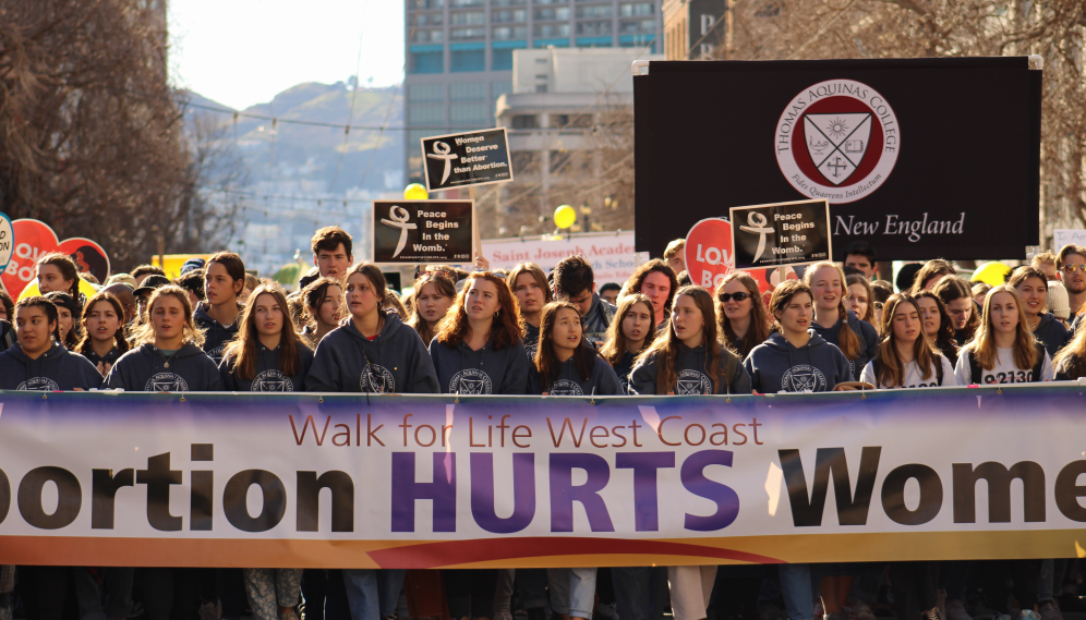 Another view of the students marching with the front sign