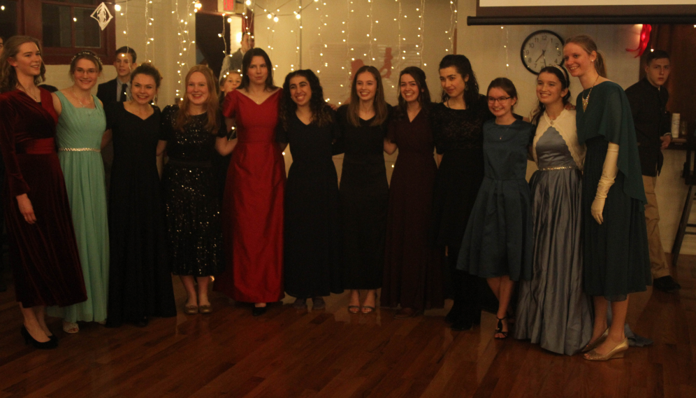 Twelve girls form a singing semicircle