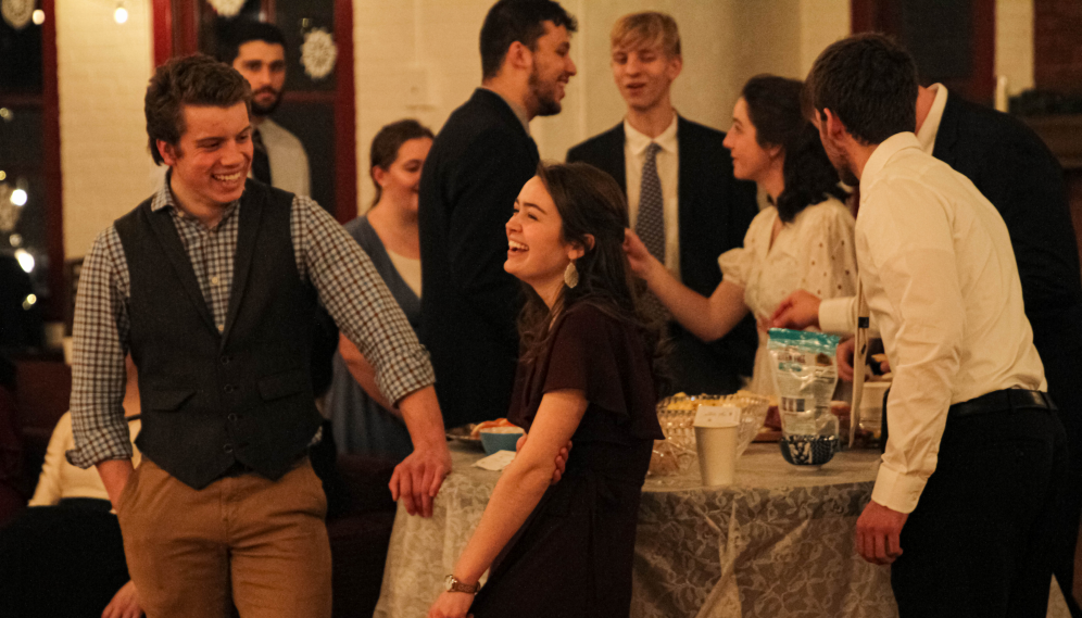 Students chat around one of the snack tables