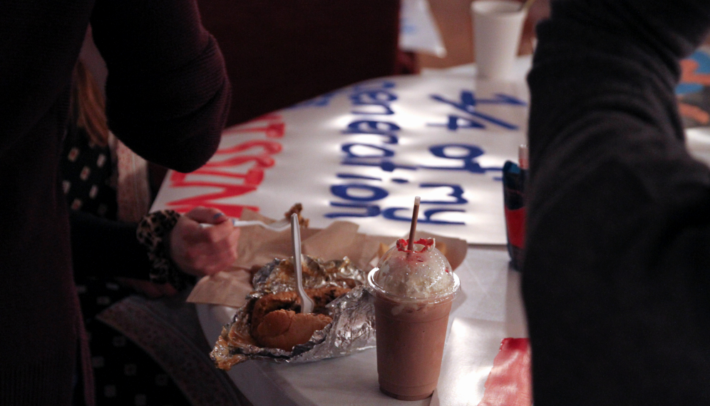 A cheesesteak and a milkshake next to a pro-life sign
