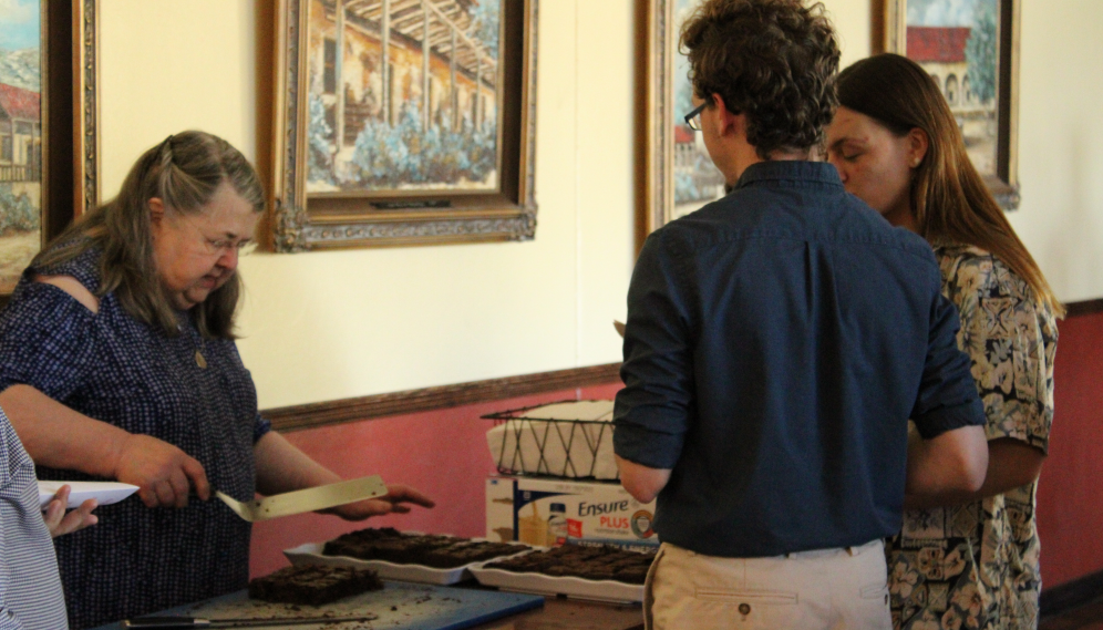 The Banana Bread Lady serves brownies to students