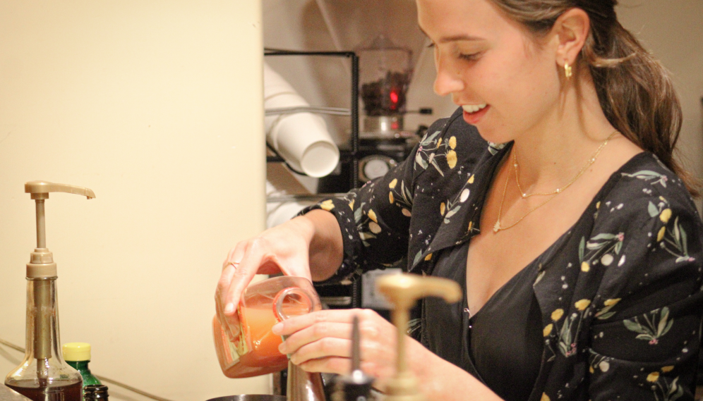 A student pours juice into the mixer