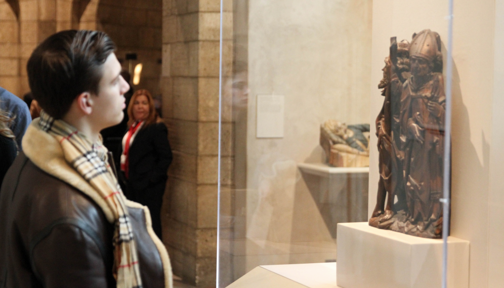 A student admires a bronze statue