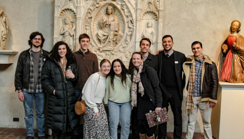 Nine pose afront the reredos