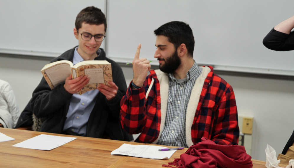 One student reads Thucydides while another points up