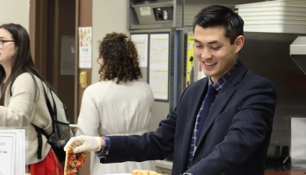 A prefect serves pizza