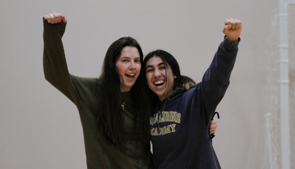 Two pose, cheering