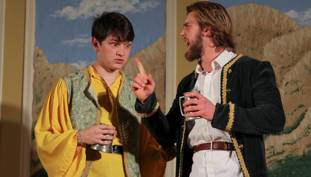 The sailor-jacketed man holds forth to the one in yellow, who looks shocked
