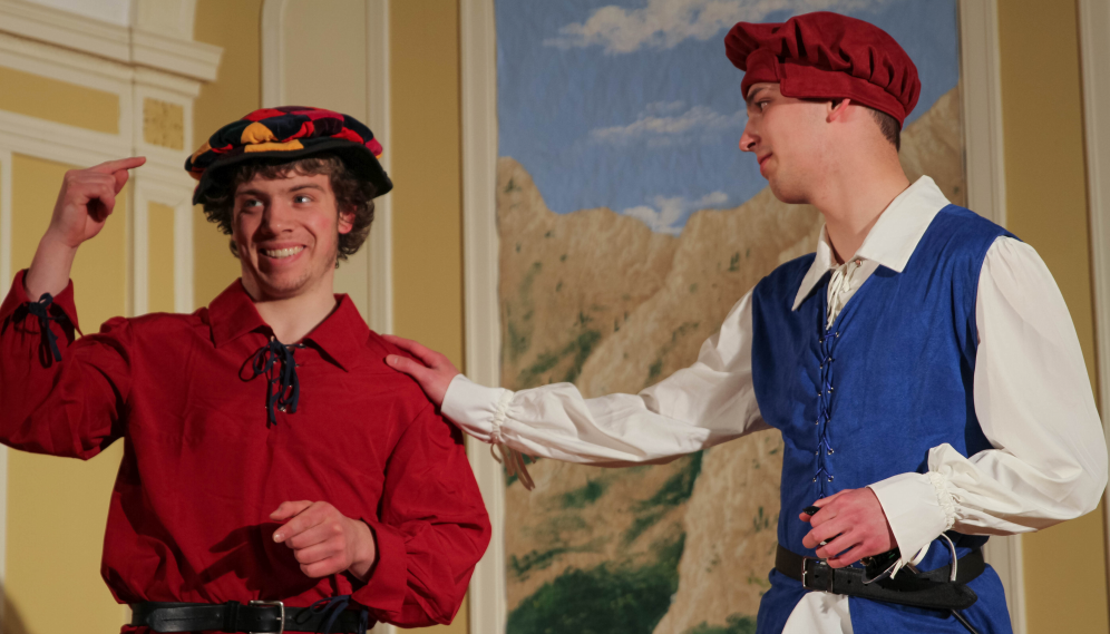 The man in red draws attention to his red-and-black lozenge-patterned hat