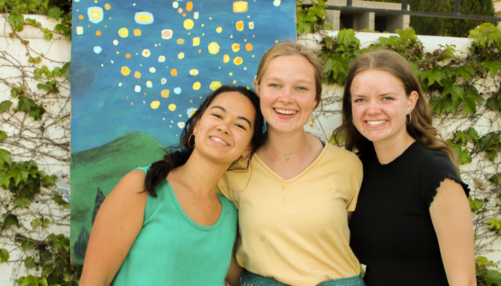 Three pose for a photo