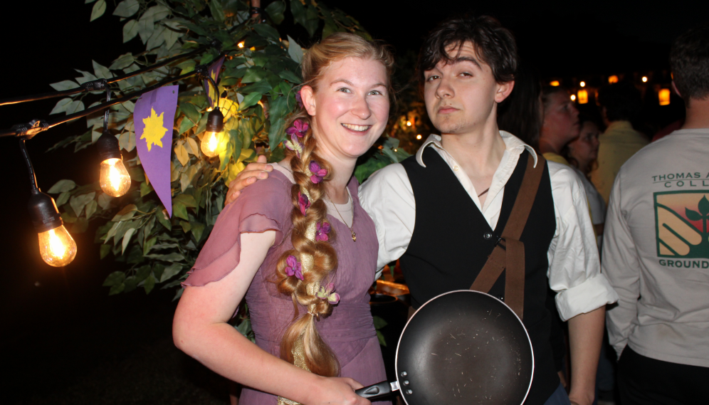 Two pose, dressed as Eugene and Rapunzel