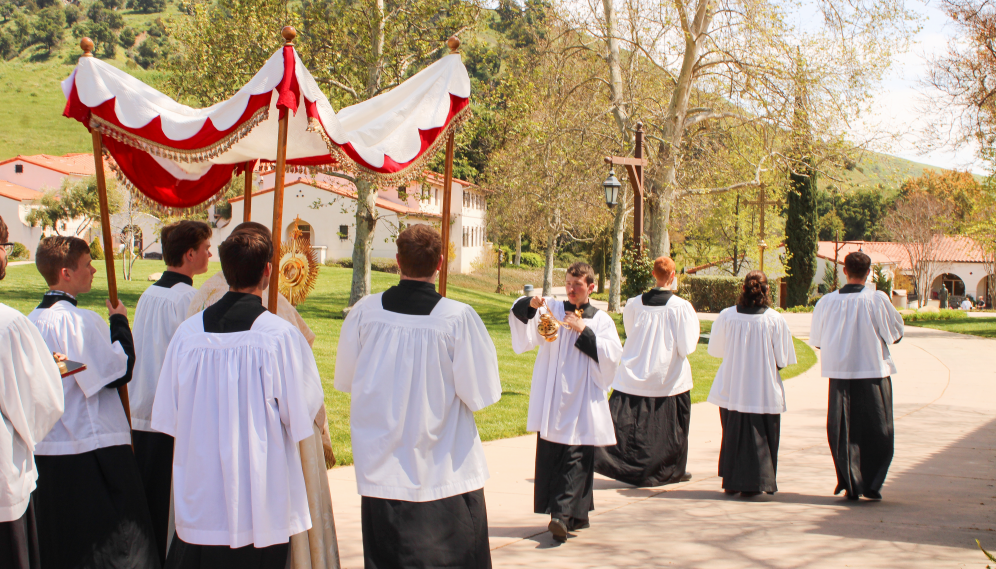 The thurifer incenses the monstrance