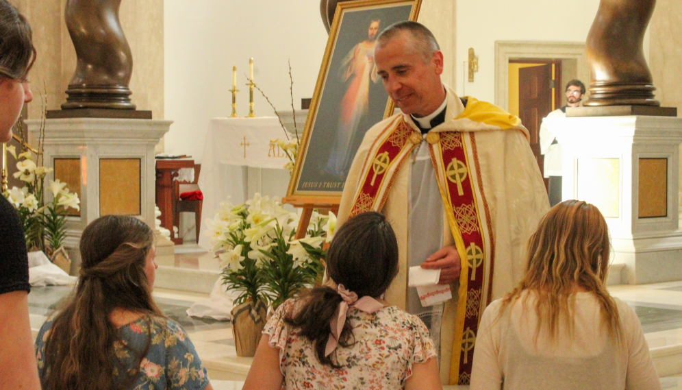 The priest offers the relic for veneration at the altar rail