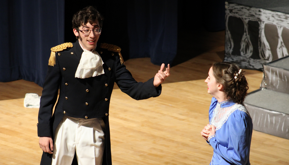 An officer in epaulettes with a girl in a blue dress