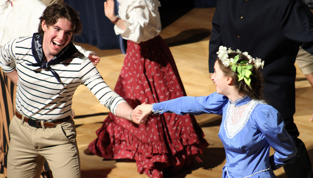 A sailor dances with the lady in blue