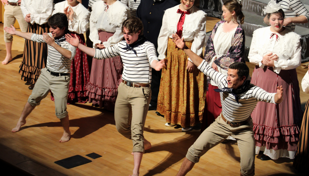 Three sailors sing and dance