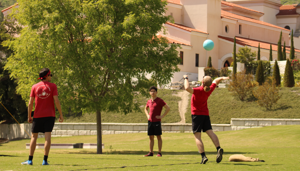 Three play volleyball