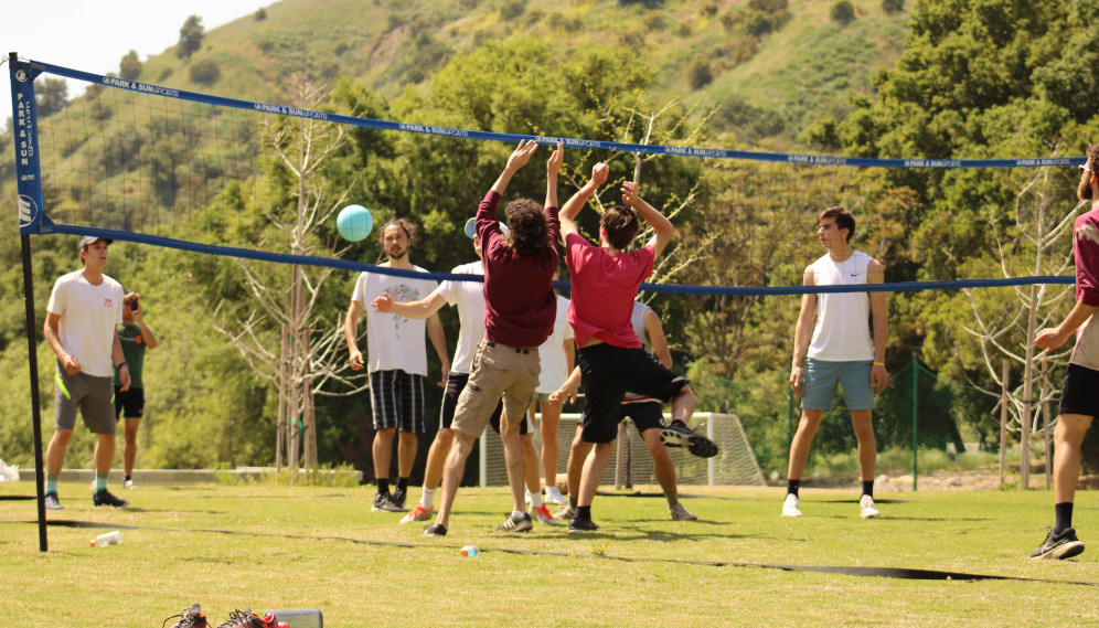 Red and white teams at the volleyball net