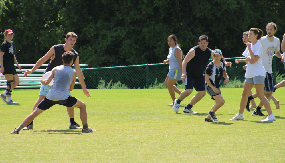 A student attempts to pass the Frisbee