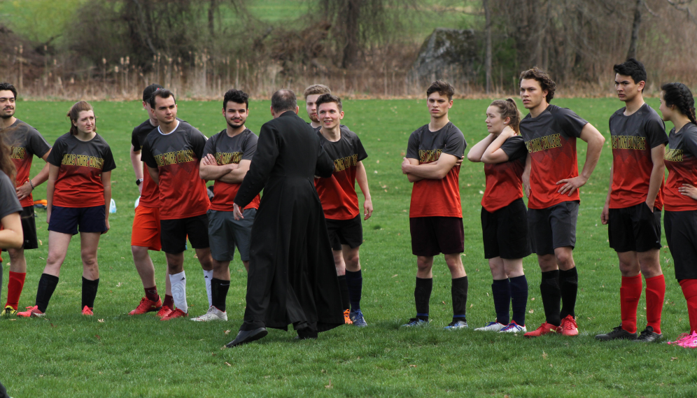 Fr. Markey shakes hands with the TMC team