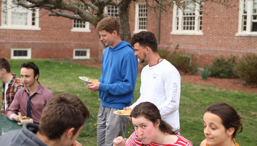 Students from both colleges settle down side-by-side to eat
