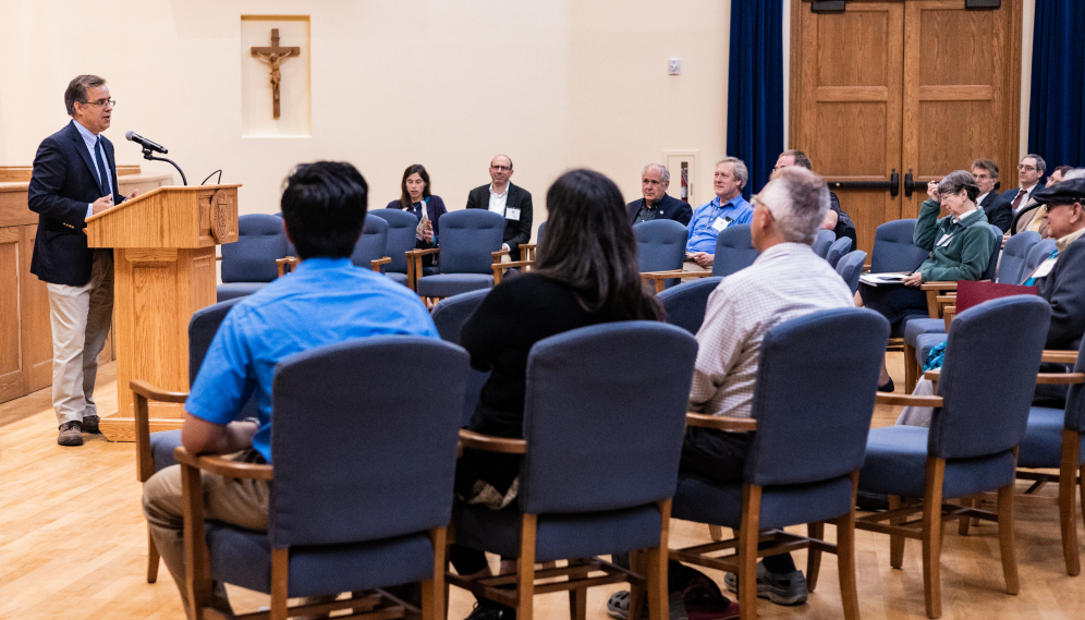 Dr. Goyette addresses the assembled scholars