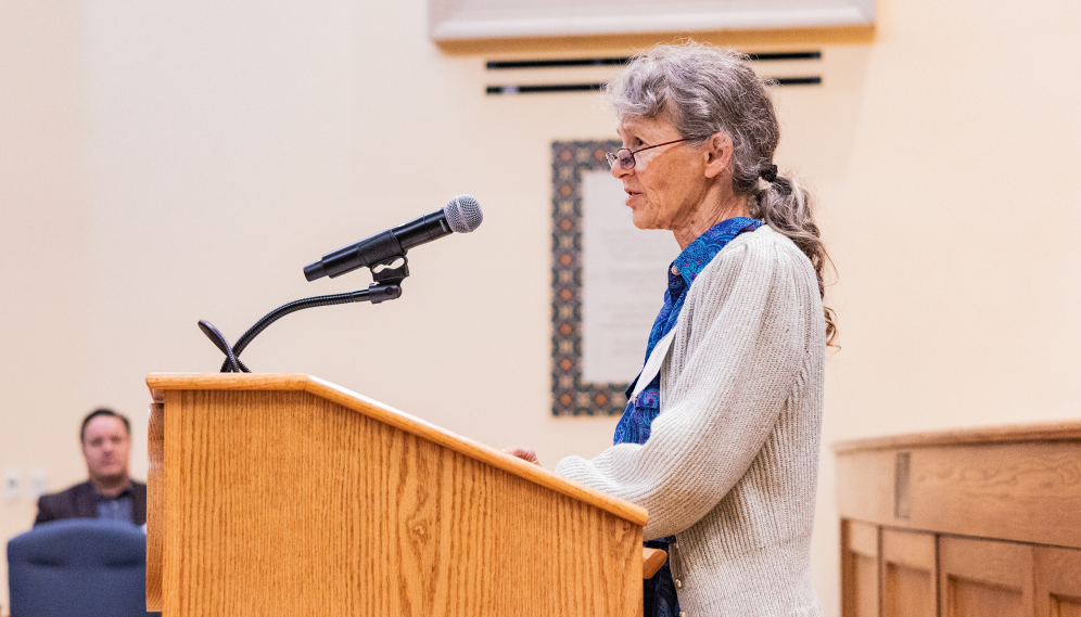 A scholar addresses the audience