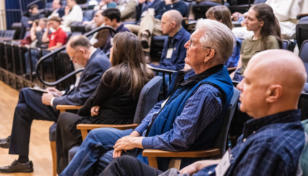 The audience listens