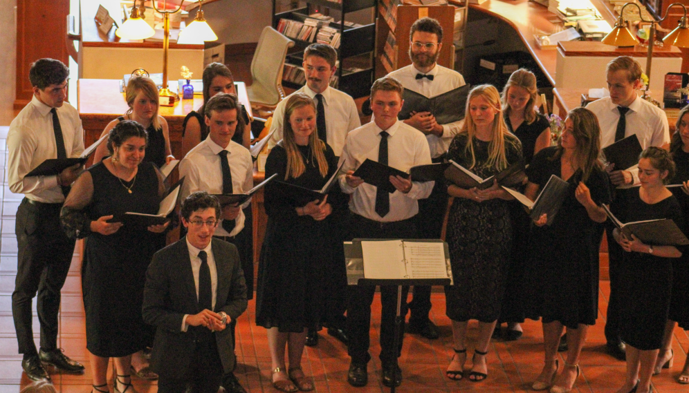 The choir director addresses the audience