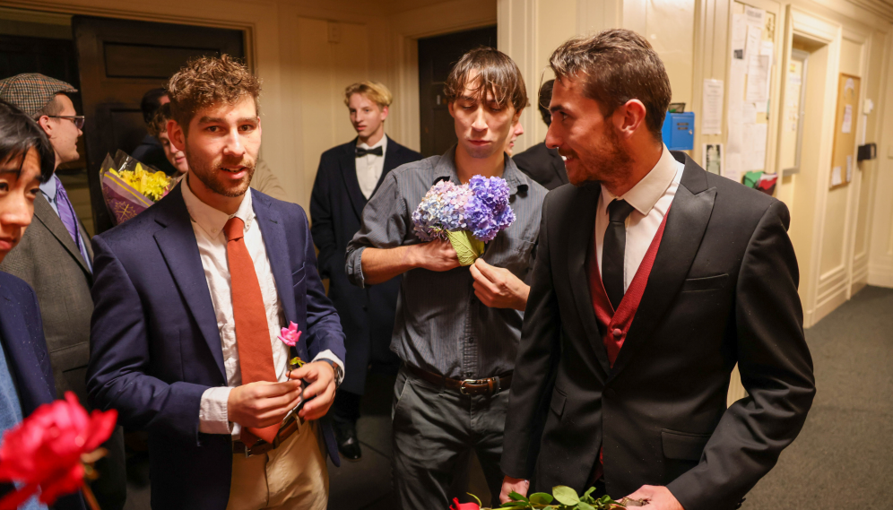 The men await their dates inside a common space of Gould hall